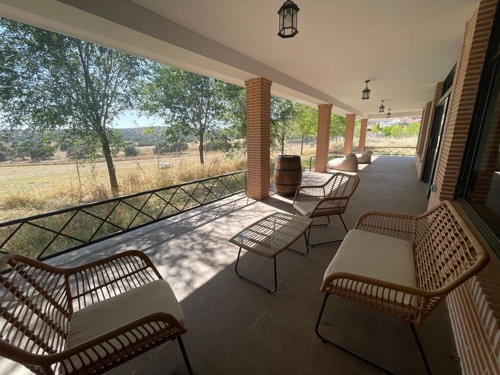 Terrace with wicker lounge chairs overlooking the Spanish countryside